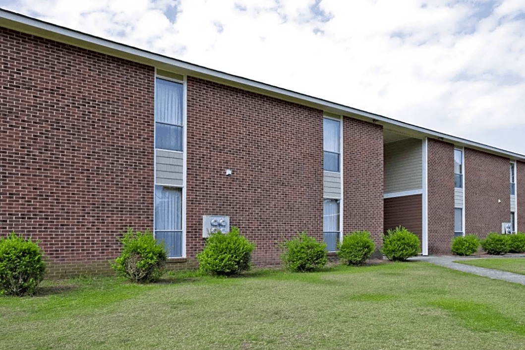 A brick building with a sign on the front.